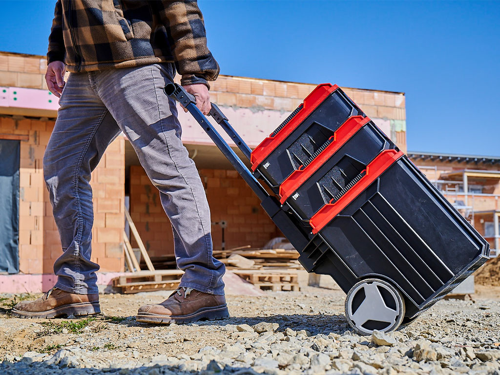 A man pulls three toolboxes