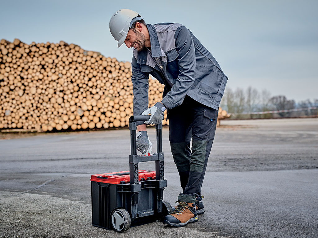 man with a helmet on his head and a toolbox in his hand