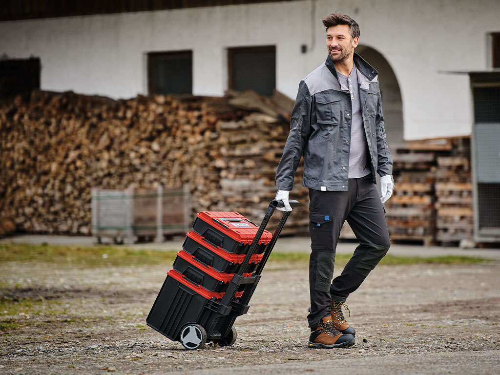 A man pulls four tool cases