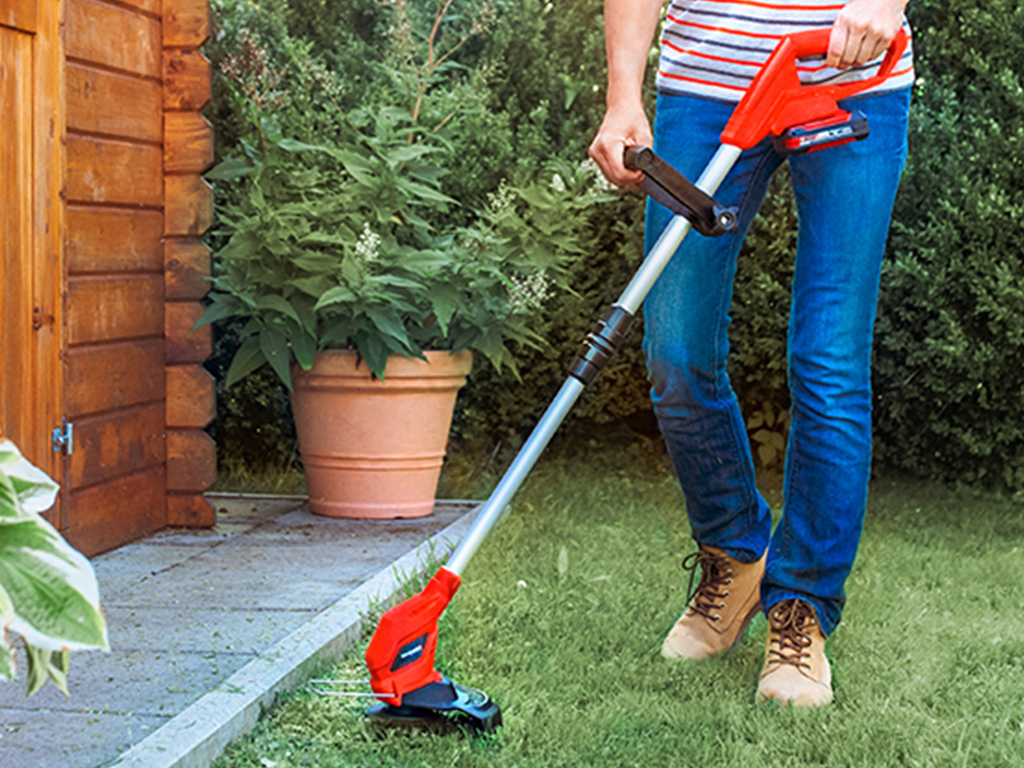 Grass is trimmed next to a wooden hut