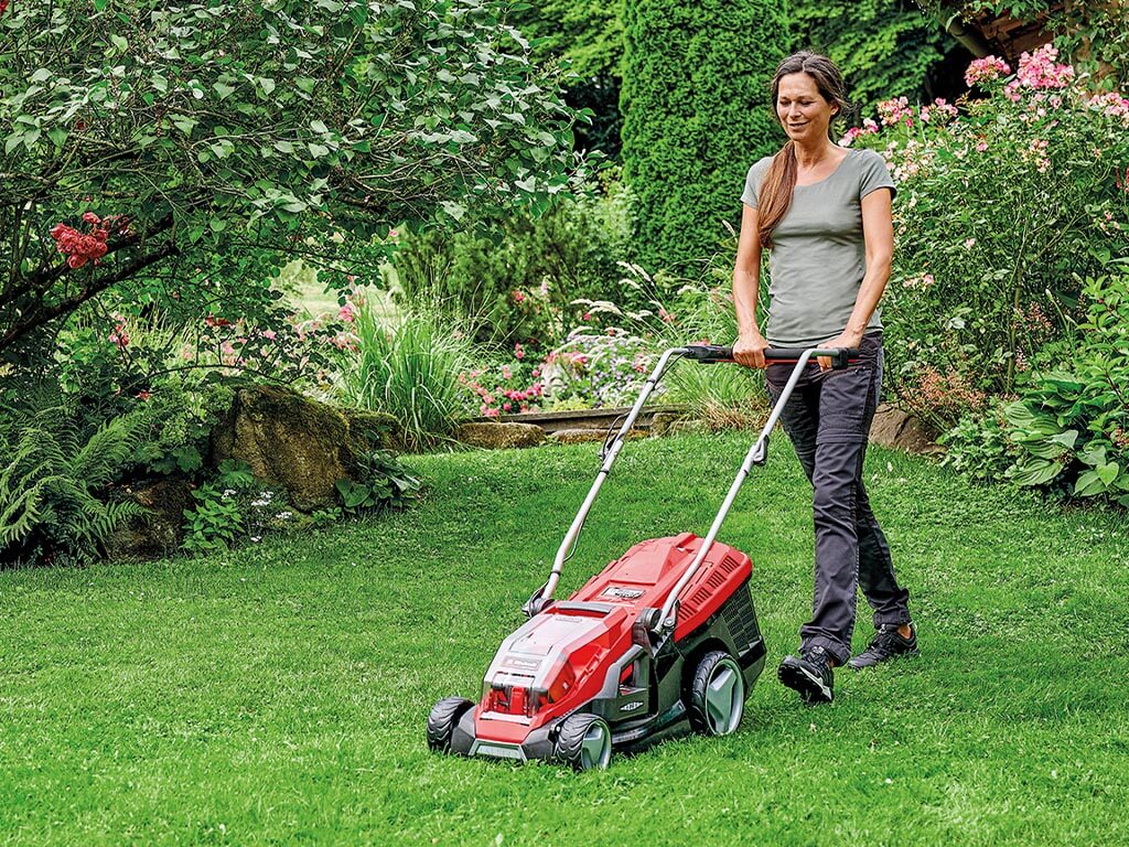 woman mows the lawn
