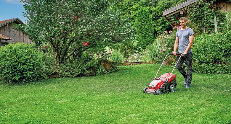 A man mowing the lawn in the garden